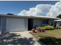 Charming single-story home with a well-maintained lawn, flowerbeds and a one car garage at 3673 Somerville Dr # 1510, Sarasota, FL 34232