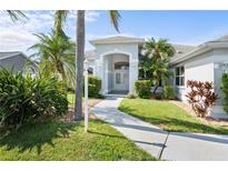Inviting front entrance with manicured landscaping, featuring a light gray facade and glass double doors at 5110 19Th W Ave, Bradenton, FL 34209