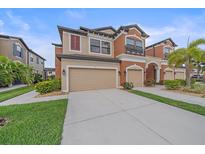 Stunning two-story townhome with attached two car garage and well-manicured lawn at 5191 78Th St E Cir, Bradenton, FL 34203