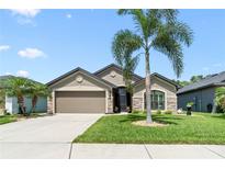Charming one-story home featuring manicured landscaping, a two-car garage and a well-maintained lawn at 9229 52Nd E Ave, Palmetto, FL 34221