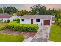 Charming single-story home with a well-manicured front yard and a one car garage at 928 Pineland Ave, Venice, FL 34285