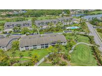 Scenic aerial view of condo community with pool, golf course, and lush landscaping at 9540 High Gate Dr # 1422, Sarasota, FL 34238