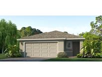 Charming single-story home featuring a two-car garage, well-maintained lawn, and fresh landscaping at 10710 Hidden Banks Gln, Parrish, FL 34219