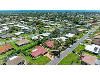 Bird's eye view of the community, showcasing the neatly arranged homes and lush greenery near the water at 216 Matisse Cir, Nokomis, FL 34275