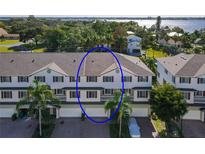 Charming two-story townhouse with red shutters, garages, and lush palm trees surrounding the property at 3409 10Th W Ln, Palmetto, FL 34221