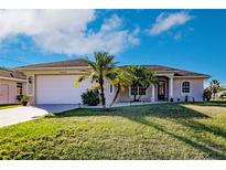Charming single-story home with well-manicured lawn and tropical landscaping, freshly painted at 3835 W Price Blvd, North Port, FL 34286