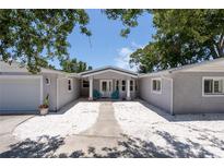 Charming single-story home with stucco siding, a covered entryway, and well-manicured landscaping at 417 Park Lane Dr, Venice, FL 34285