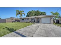 Charming single-story home featuring a well-manicured lawn, and a welcoming front entrance at 4611 Spahn St, Sarasota, FL 34232