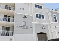 Attractive condo building featuring Harbor Villas with balconies and neutral toned exterior paint at 516 Tamiami S Trl # 306, Nokomis, FL 34275