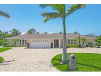 Stunning single story home with a brick driveway, manicured landscaping, and a pristine two car garage at 7913 19Th Avenue W Dr, Bradenton, FL 34209