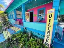 Colorful building displaying Village of the Arts signage, offering a vibrant and artistic community setting at 1019 10Th W Ave, Bradenton, FL 34205
