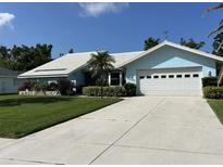 Charming one-story home with a well-manicured lawn and inviting curb appeal and neutral colored driveway at 1279 Vermeer Dr, Nokomis, FL 34275