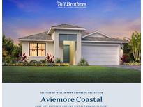 Beautiful single-story home with a manicured lawn, neutral color palette, and a two-car garage, embodying luxury living at 12996 Morning Mist Pl, Venice, FL 34293