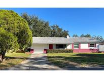 Charming single-story home with a well-manicured lawn and a vibrant exterior paint scheme at 2833 62Nd N St, St Petersburg, FL 33710