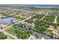 Expansive aerial view of canal-front home, showcasing waterfront access and lush surroundings at 3500 Liberty St, Port Charlotte, FL 33948