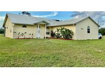 Charming single-story home with manicured lawn and lush landscaping around the front entrance at 4353 Hidden River Rd, Sarasota, FL 34240