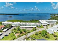 Stunning aerial view of waterfront condos, lush landscaping, and serene bay waters on a sunny day at 4736 Independence Dr # 4736, Bradenton, FL 34210