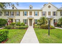 Beautiful townhome with manicured landscaping, charming shutters, and a welcoming walkway at 5646 Simonton St, Bradenton, FL 34203