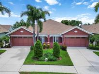 Charming home with landscaped front yard, a double driveway, and attached two-car garage offering curb appeal at 7314 Hamilton Rd, Bradenton, FL 34209