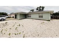 Charming single-story home with light blue exterior, featuring a rock garden and well-maintained yard at 8409 43Rd W Ave, Bradenton, FL 34209