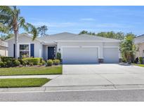 Charming one-story home with a three-car garage, well-manicured lawn, and lush landscaping at 15508 High Bell Pl, Bradenton, FL 34212