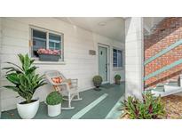 Inviting front porch with rocking chair, potted plants, and a view of the entrance at 1838 Restful Dr # K-1, Bradenton, FL 34207