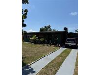 Charming one-story home featuring a chimney, long driveway, and a well-kept lawn at 1905 Roslyn Ave, Bradenton, FL 34207