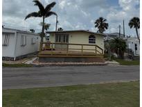 Charming single-story home featuring a cozy front porch and well-maintained landscaping at 2601 Gulf N Dr # B4, Bradenton Beach, FL 34217