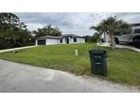 A beautifully landscaped front yard and modern single-story home at 3387 Tupelo Ave, North Port, FL 34286