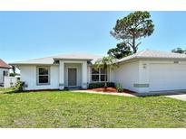 Charming single-story home with a well-maintained lawn, mature trees, and an attached two-car garage at 4484 Tortoise Rd, Venice, FL 34293