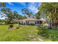 Charming single story home with a well-manicured lawn and mature trees enhancing its curb appeal at 5356 Royal Palm Ave # 5356, Sarasota, FL 34234