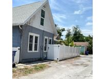 Exterior view of blue home with a white fence at 783 30Th N Ave, St Petersburg, FL 33704