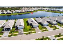 Beautiful aerial view of lakeside homes featuring manicured lawns and paver driveways at 8148 Sternway Rd, Sarasota, FL 34240