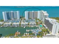Stunning aerial view of waterfront condos with marina, pool, and beautiful ocean views at 988 Blvd Of The Arts # 1016, Sarasota, FL 34236