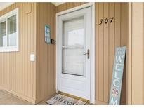 Charming condo entrance with welcoming decor and exterior unit number at 150 Harborside Ave # 307, Punta Gorda, FL 33950