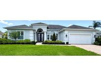 Charming single-story home with a well-manicured lawn, complemented by lush landscaping and a two-car garage at 1539 Ormond Ter, Parrish, FL 34219