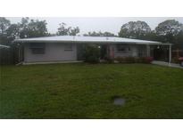 Charming single-story home featuring a well-manicured lawn and blooming flower beds at 2787 Jay Pl, Sarasota, FL 34235