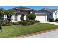 Charming single-story home boasts a well-manicured lawn and beautiful landscaping at 4257 Hearthstone Dr, Sarasota, FL 34238