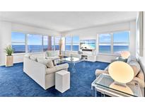 Bright living room with ocean views from large windows and modern furnishings at 601 Longboat Club Rd # 504S, Longboat Key, FL 34228
