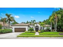 Charming home featuring mature landscaping, a well-manicured lawn, and a welcoming entrance at 6839 Turnberry Isle Ct, Lakewood Ranch, FL 34202
