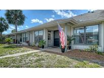 Charming single-story home featuring a cozy porch and lush landscaping at 946 N Beneva Rd # V26, Sarasota, FL 34232