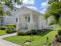 Charming single-story home with a manicured lawn, a quaint front porch, and beautiful curb appeal at 12682 Shimmering Oak Cir, Venice, FL 34293
