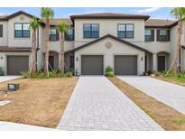Charming townhome featuring an attached garage and a well-manicured front yard at 14835 Lyla Ter, Bradenton, FL 34211