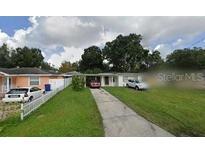 Cozy single-story home features a well-manicured lawn and driveway for easy parking, perfect for suburban living at 3219 W Grace St, Tampa, FL 33607
