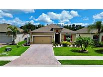 Charming single-story home boasts manicured lawn, brick paver driveway, and colorful landscaping at 3712 76Th E St, Palmetto, FL 34221