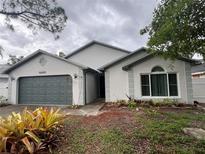 Charming single-story home features a well-maintained yard and two-car garage at 4441 Groveland Ave, Sarasota, FL 34231