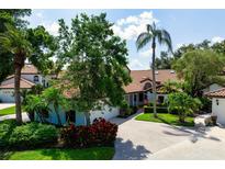 Aerial view of the property showcasing lush landscaping and a well-maintained home with a red tile roof at 4472 Calle Serena, Sarasota, FL 34238