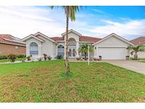 Charming single-story home with a well-manicured lawn and a beautiful red tile roof at 7327 38Th Court East, Sarasota, FL 34243