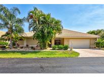 Charming single-story home with a two-car garage, beautiful landscaping, and a well-maintained front yard at 105 Inlets Blvd # 105, Nokomis, FL 34275