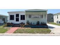 Charming home featuring a cozy front garden and an inviting facade with ample natural light at 3402 Shingle Oak Ter, Sarasota, FL 34237